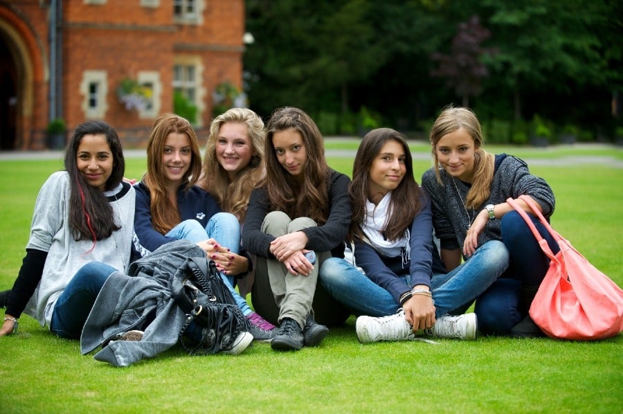 These girls all share an apartment that is international student housing. They are roommates or apartment mates.